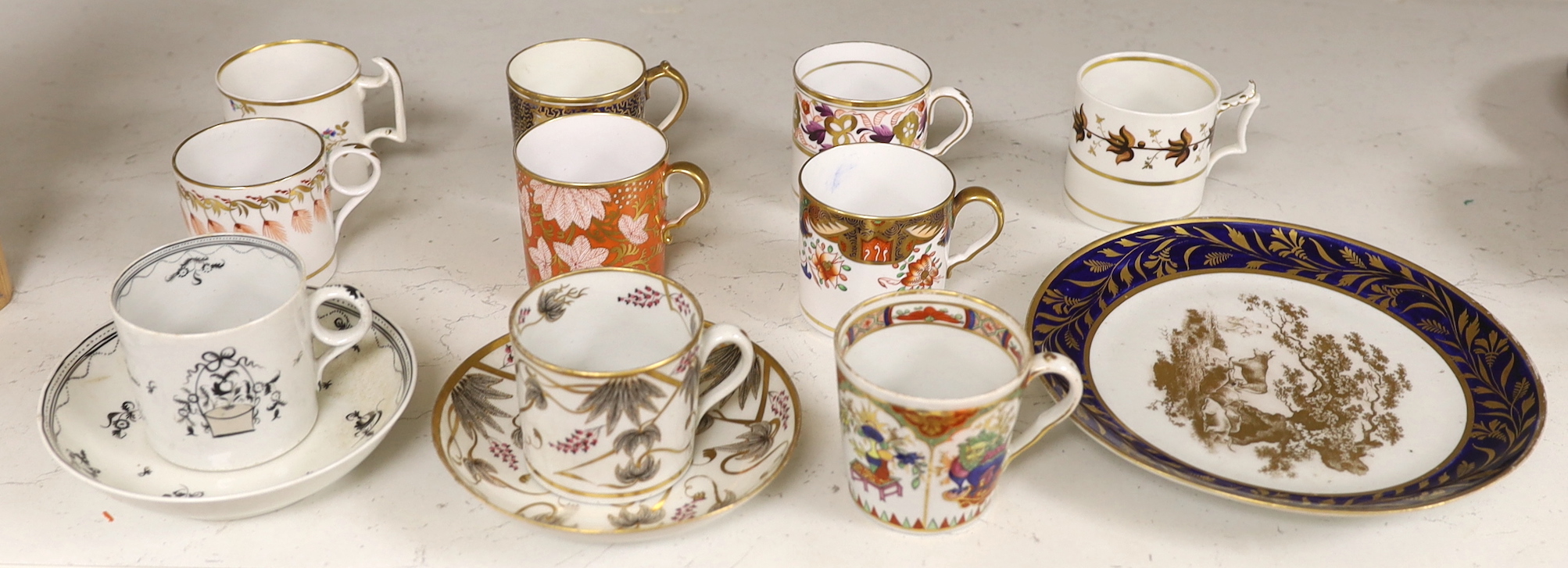 English porcelain coffee cans including Worcester, Spode, Wolfe Mason, Derby and Chamberlain, two New hall cans and saucers and a New hall Warburton’s Patent saucer dish, the largest 20cm in diameter